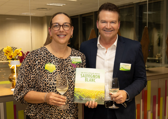 Elunda Basson, chairperson of Sauvignon Blanc SA, hands a copy of The Story of South African Sauvignon Blanc to Stephan Claassen, provincial head of FNB Business for the Western and Eastern Cape. Photo: Andrew Gorman Photography